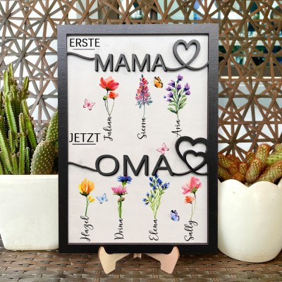 Personalisierter Holzrahmen mit dem Aufdruck „Erste Mama, jetzt Oma“ und Geburtsmonat-Blumen, mit den Namen der Kinder. Ein einzigartiges Geburtstagsgeschenk für Mama oder Oma und kreative Geschenkideen zum Muttertag.